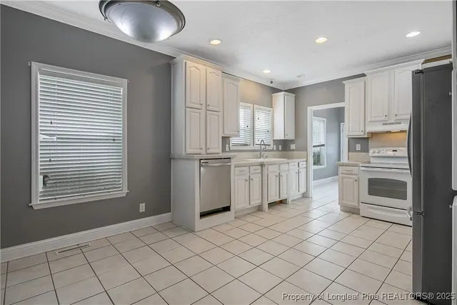 a kitchen with white cabinets and white appliances