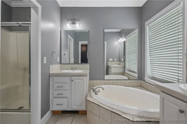 a bathroom with a tub sink and mirror
