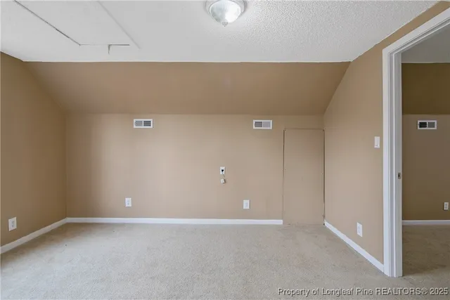 a view of an empty room and closet area