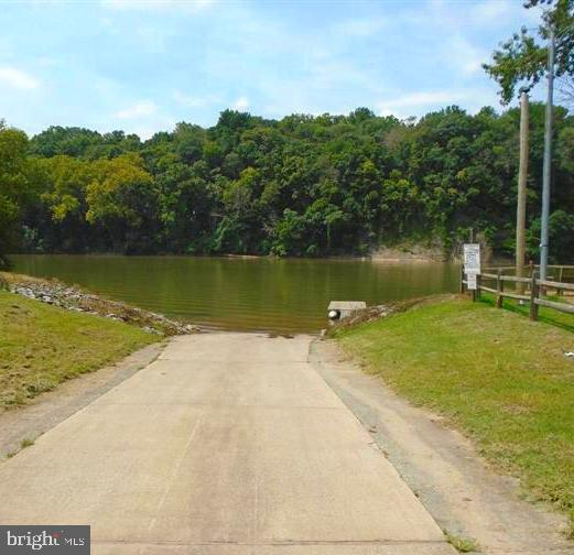 10 Block Deadwood Drive Falling Waters, WV 25419 - Photo 5 of 6 a view of a lake with a yard and a wooden bridge
