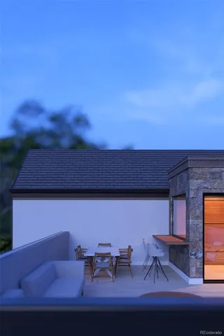 a backyard of a house with table and chairs