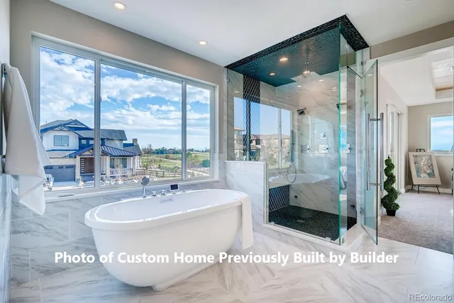 a spacious bathroom with a tub and a sink