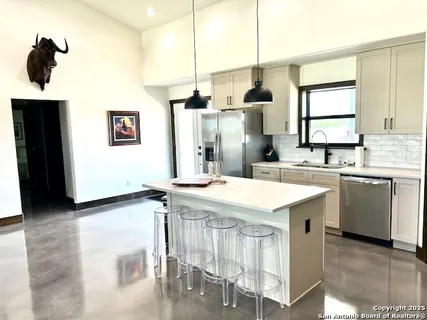a kitchen with a sink refrigerator and microwave