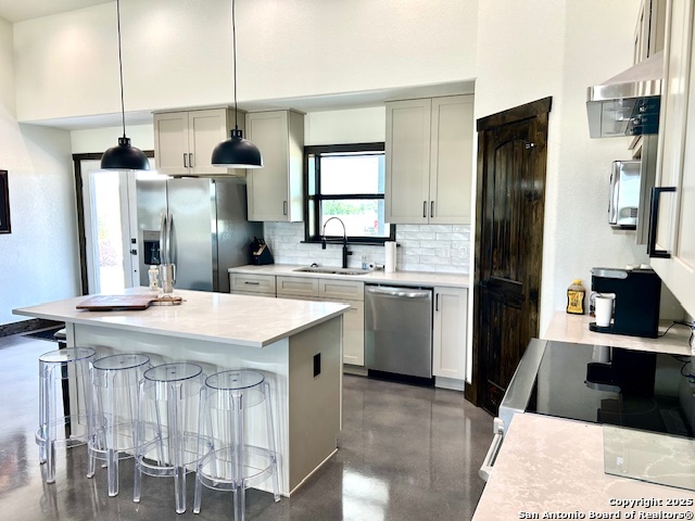 Ih Ih 35th Moore, TX 78057 - Photo 5 of 22 a kitchen with stainless steel appliances kitchen island a table chairs in it and wooden floors