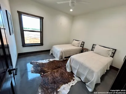 a bedroom with two beds and a window