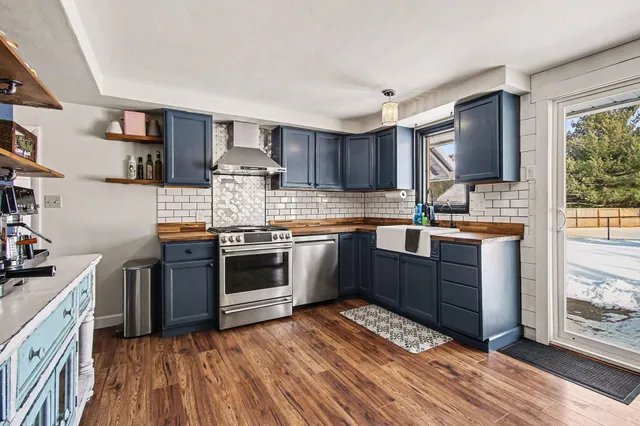 a kitchen with a stove a sink and a microwave