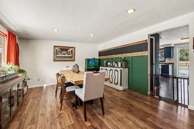 a view of a dining room with furniture window and wooden floor