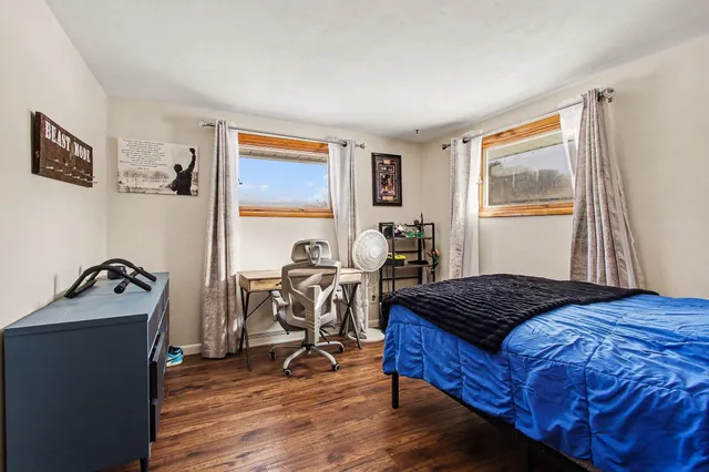 a bedroom with bed and a window