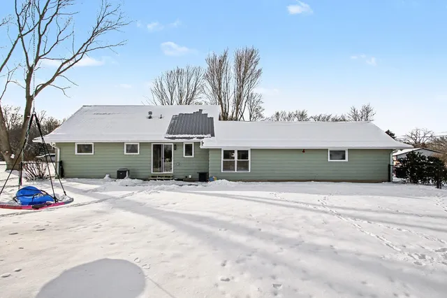 a front view of a house with a dirt yard