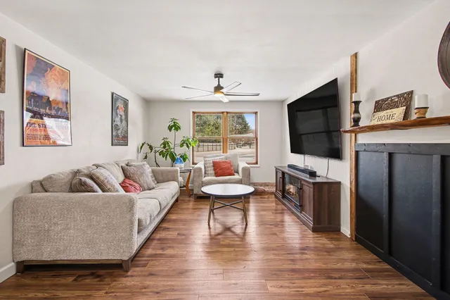 a living room with fireplace furniture and a flat screen tv