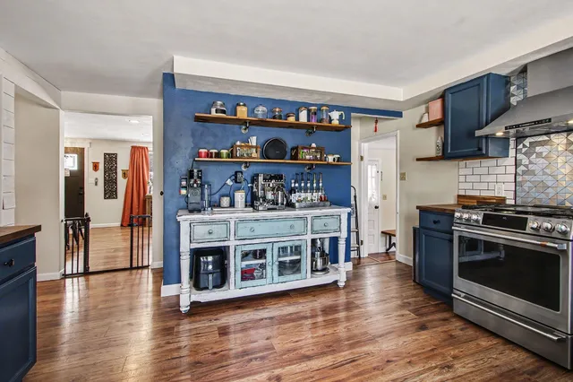 a kitchen with stainless steel appliances granite countertop a stove and a refrigerator