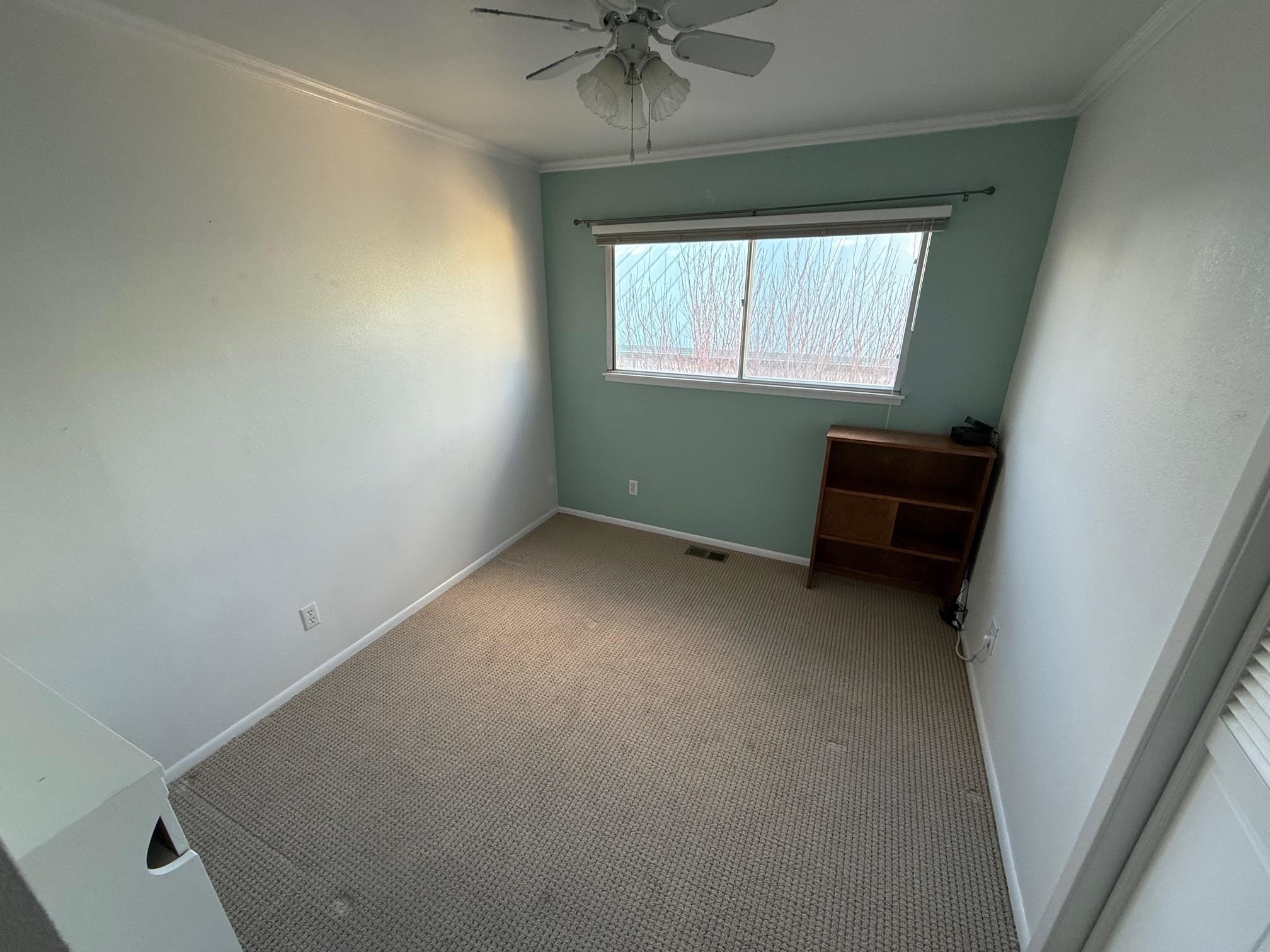 323 Main Street Bridgeport, CA 93517 - Photo 13 of 38 an empty room with a window and a fan