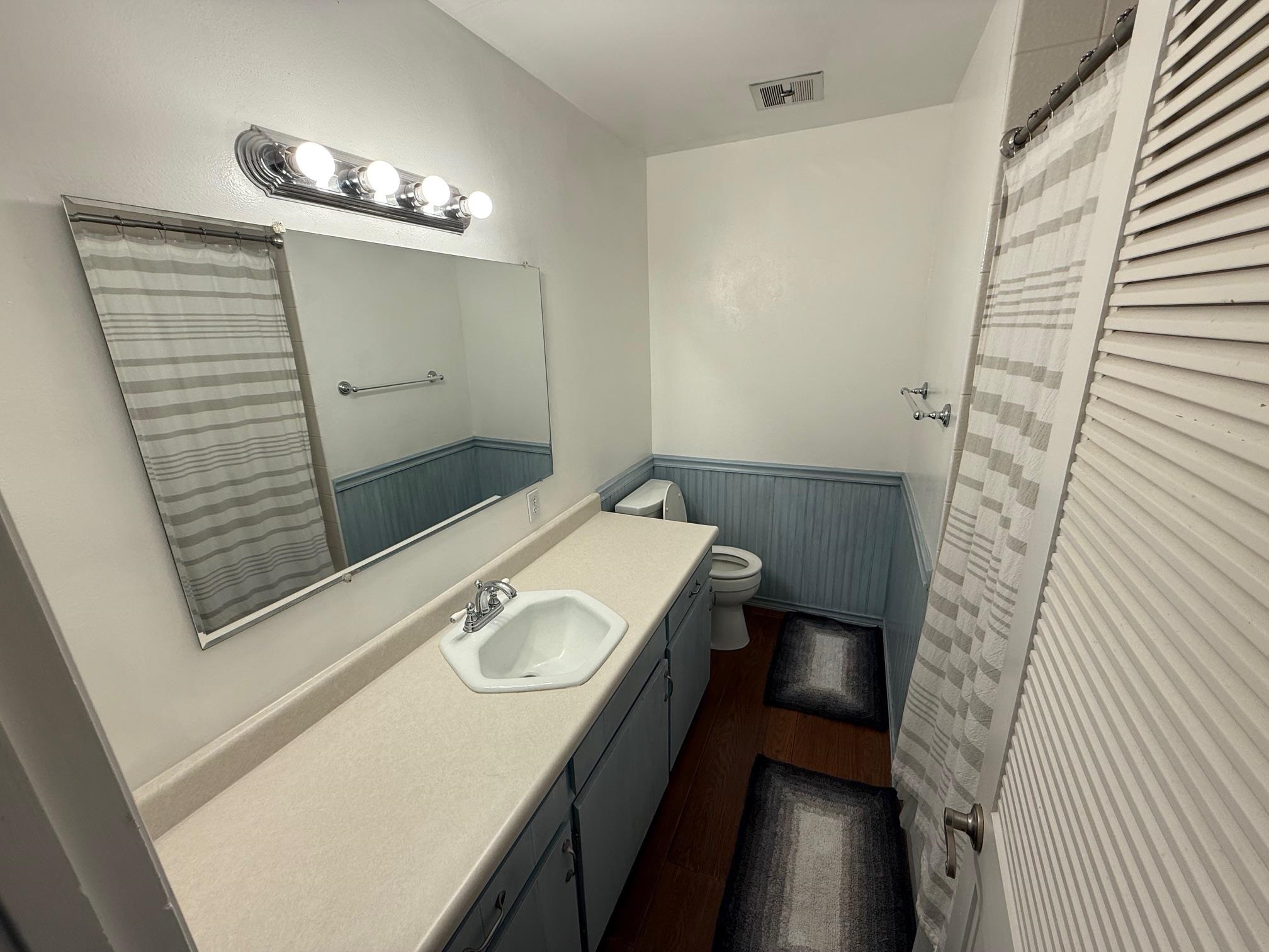 323 Main Street Bridgeport, CA 93517 - Photo 15 of 38 a bathroom with a sink a mirror and shower