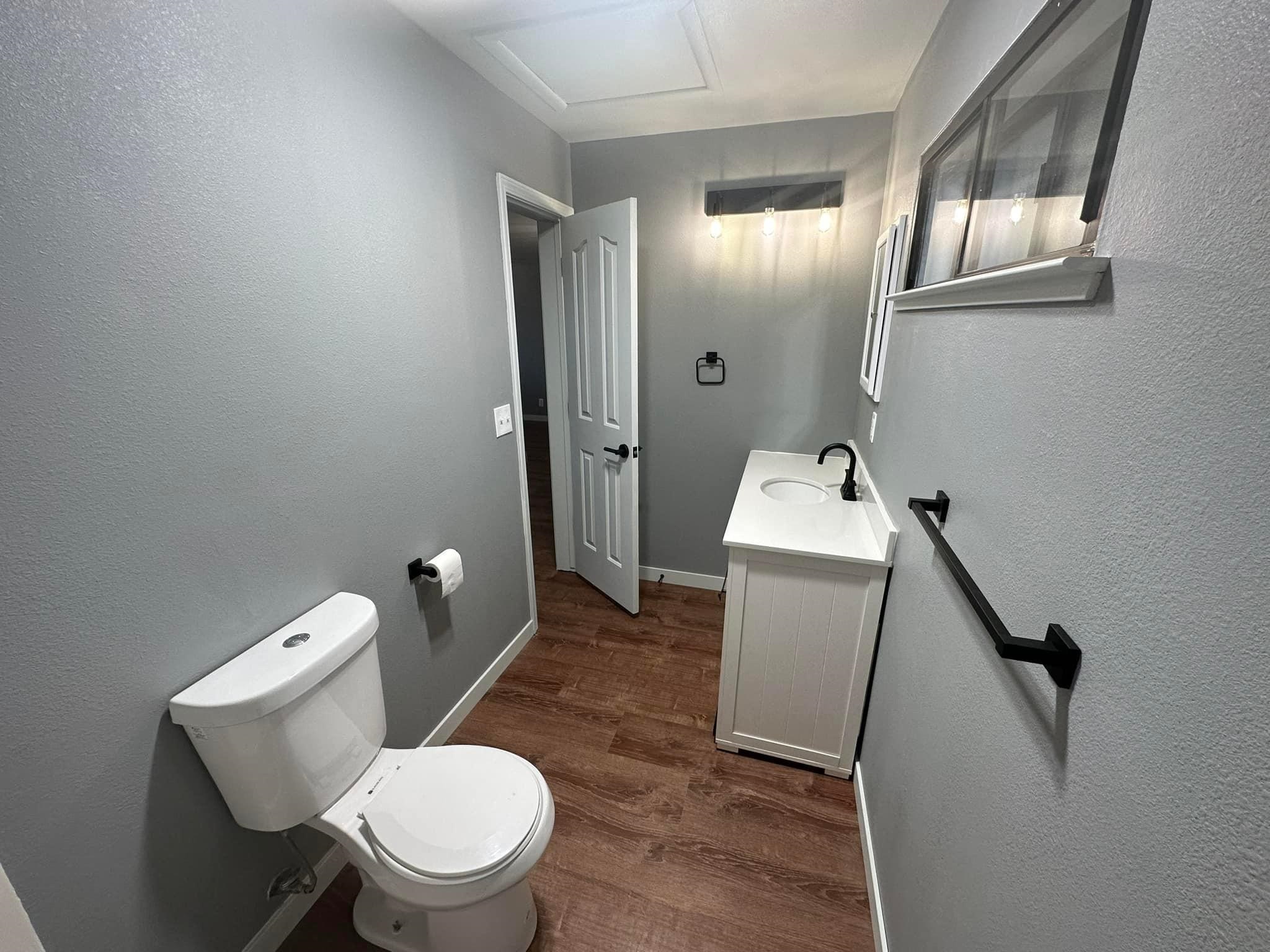 323 Main Street Bridgeport, CA 93517 - Photo 27 of 38 a white toilet sitting next to a bathroom sink