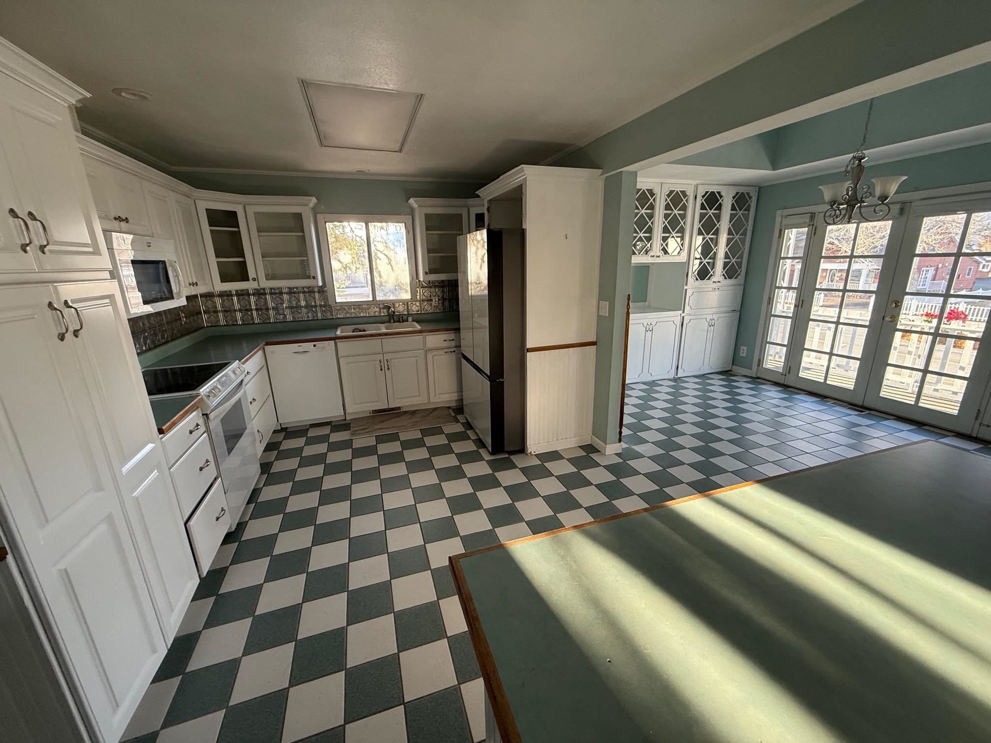 323 Main Street Bridgeport, CA 93517 - Photo 10 of 38 a kitchen with a checkered floor and a refrigerator