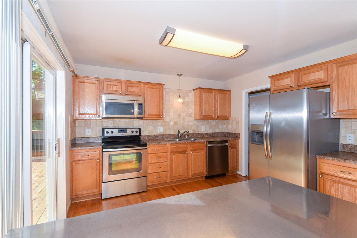 2947 Purple Finch Road Roanoke, VA 24018 - Photo 6 of 31 a kitchen with stainless steel appliances granite countertop a stove a sink and a refrigerator
