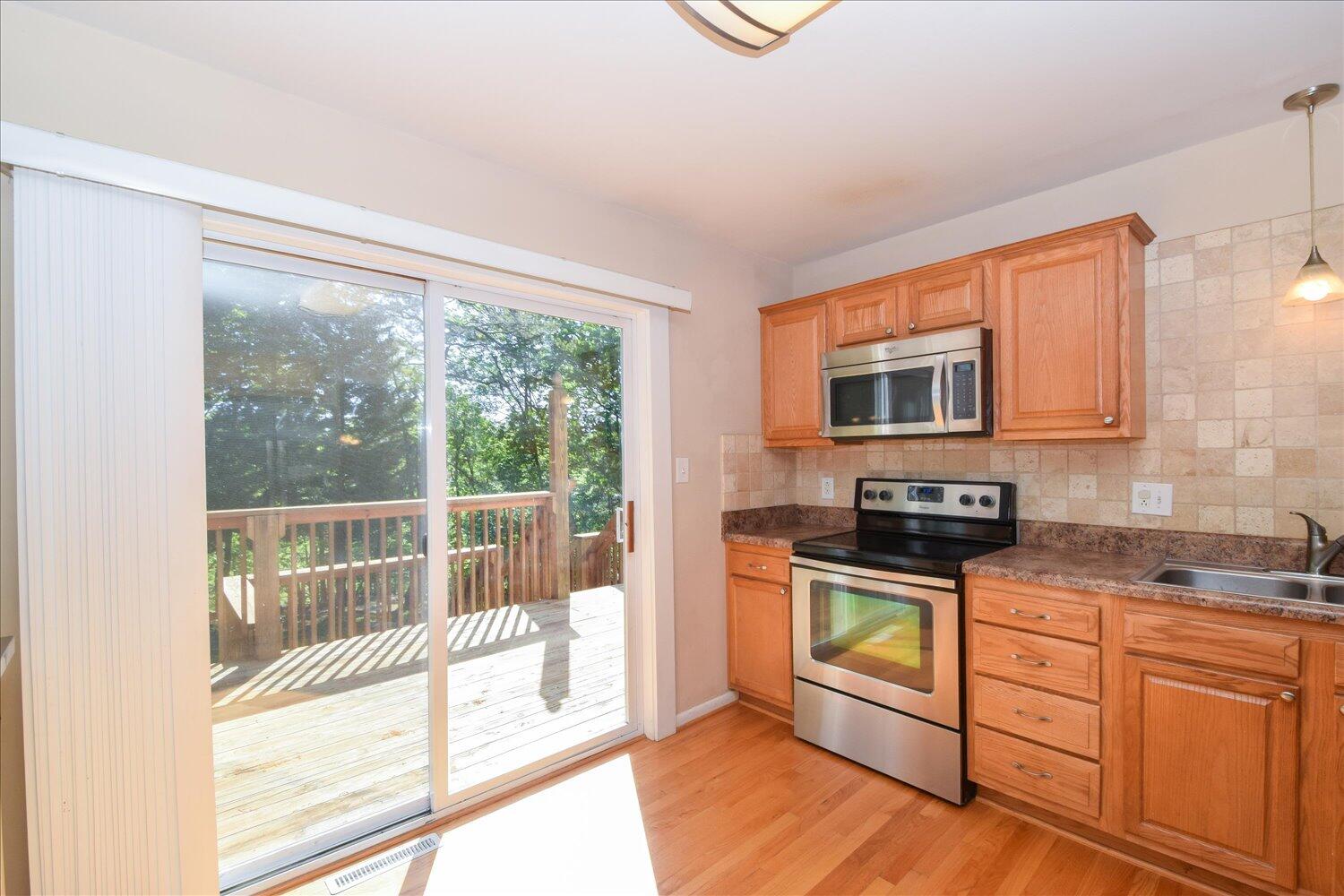 2947 Purple Finch Road Roanoke, VA 24018 - Photo 7 of 31 a kitchen with stainless steel appliances granite countertop a stove a sink and a microwave