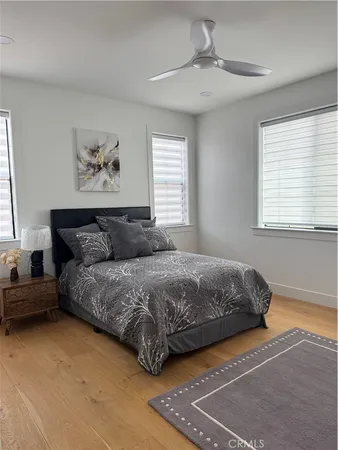 a spacious bedroom with a bed and a window