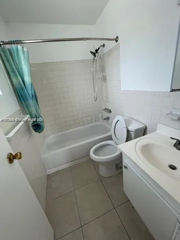 a bathroom with a toilet a sink and bathtub