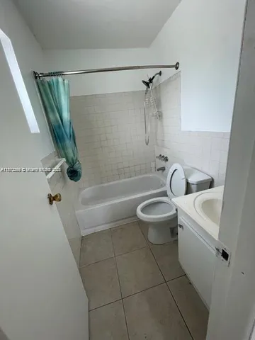 a bathroom with a sink a toilet a mirror and a glass door shower