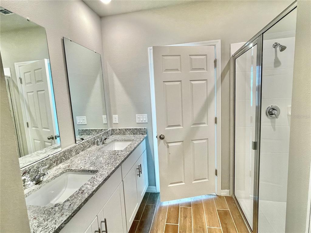 5232 Stephs Field Street St. Cloud, FL 34771 - Photo 19 of 43 a bathroom with a granite countertop sink and a mirror
