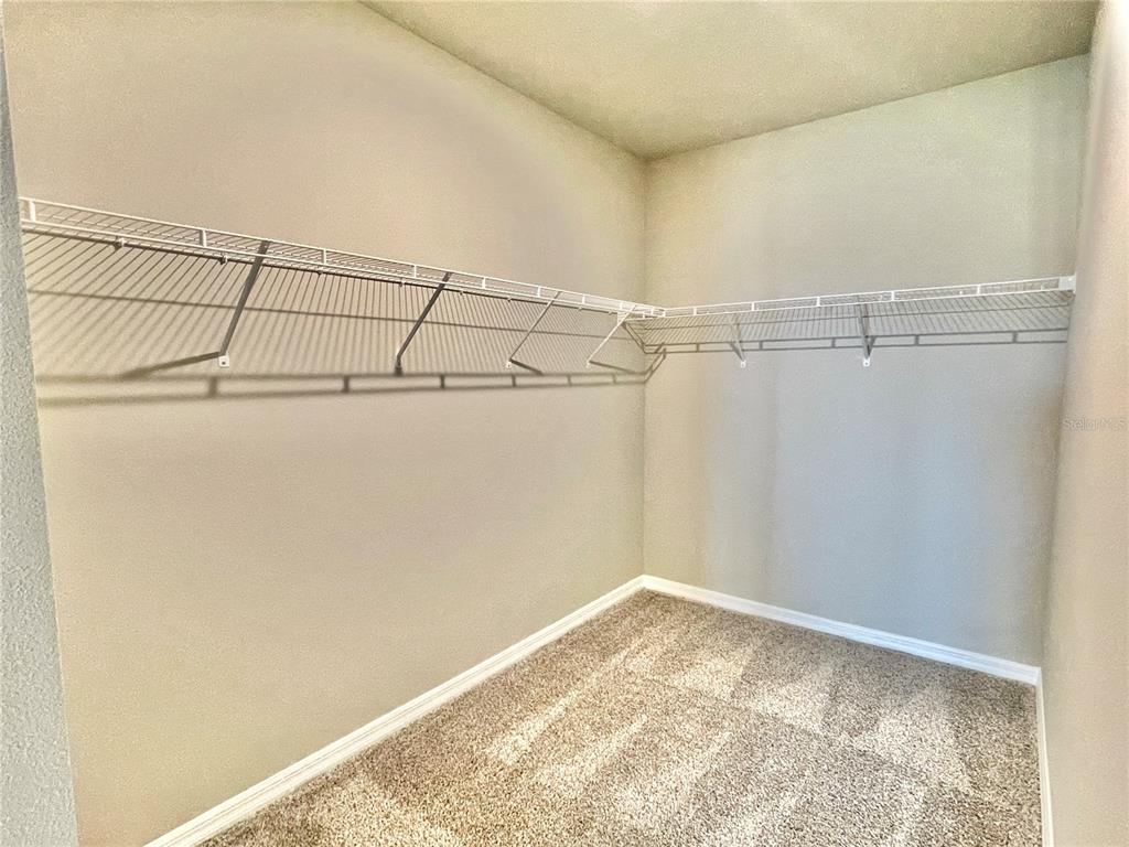 5232 Stephs Field Street St. Cloud, FL 34771 - Photo 21 of 43 a view of a room with racks on the wall