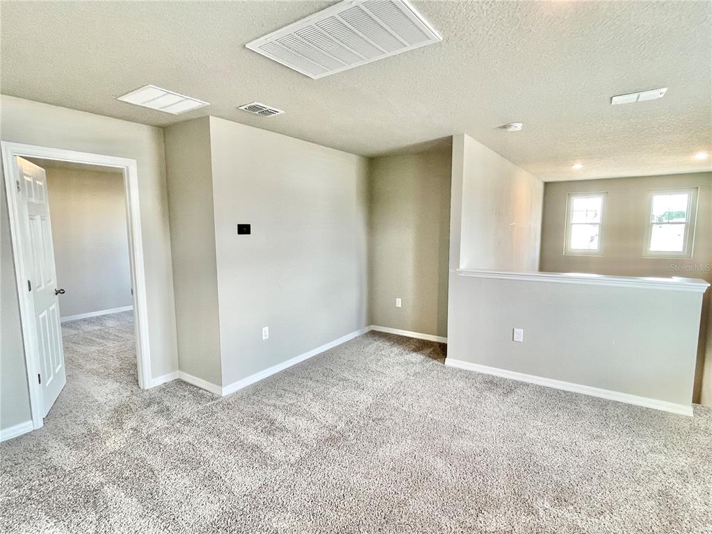 5232 Stephs Field Street St. Cloud, FL 34771 - Photo 29 of 43 an empty room with a bathroom and a mirror