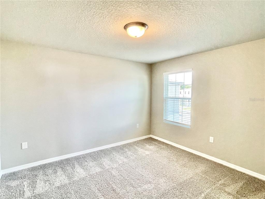 5232 Stephs Field Street St. Cloud, FL 34771 - Photo 31 of 43 a view of a room with wooden floor and window
