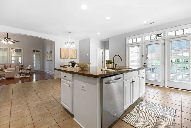 a kitchen with granite countertop a sink and a stove