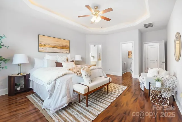 a bedroom with furniture and wooden floor