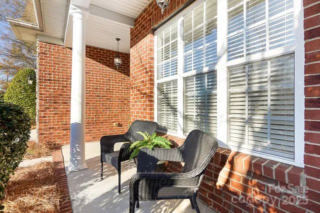 a view of balcony with a couple of chairs