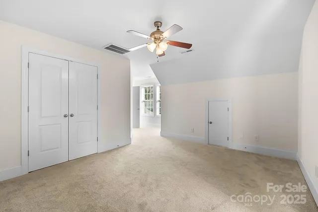 a view of a livingroom with a chandelier fan
