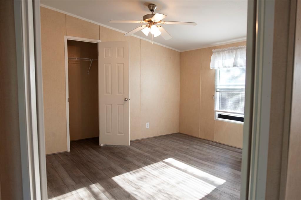 112 Southeast Front Street Bailey, TX 75452 - Photo 8 of 38 a view of an empty room with window and wooden floor