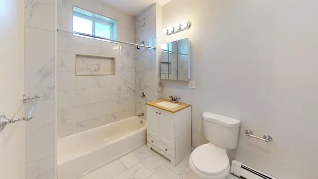 a bathroom with a toilet and a bathtub