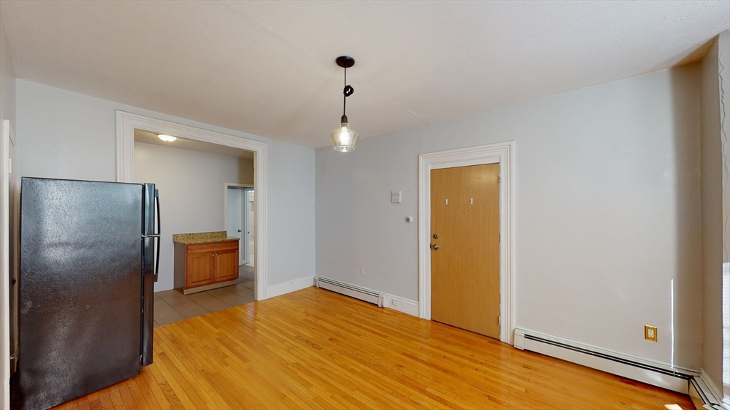 2999 Washington Street, Unit 1 Boston, MA 02119 - Photo 5 of 18 a view of empty room with wooden floor
