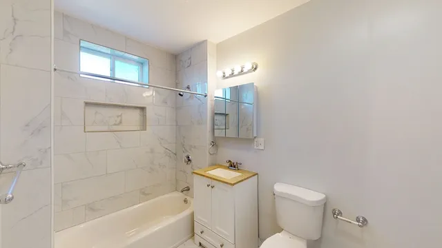 a bathroom with a toilet and shower