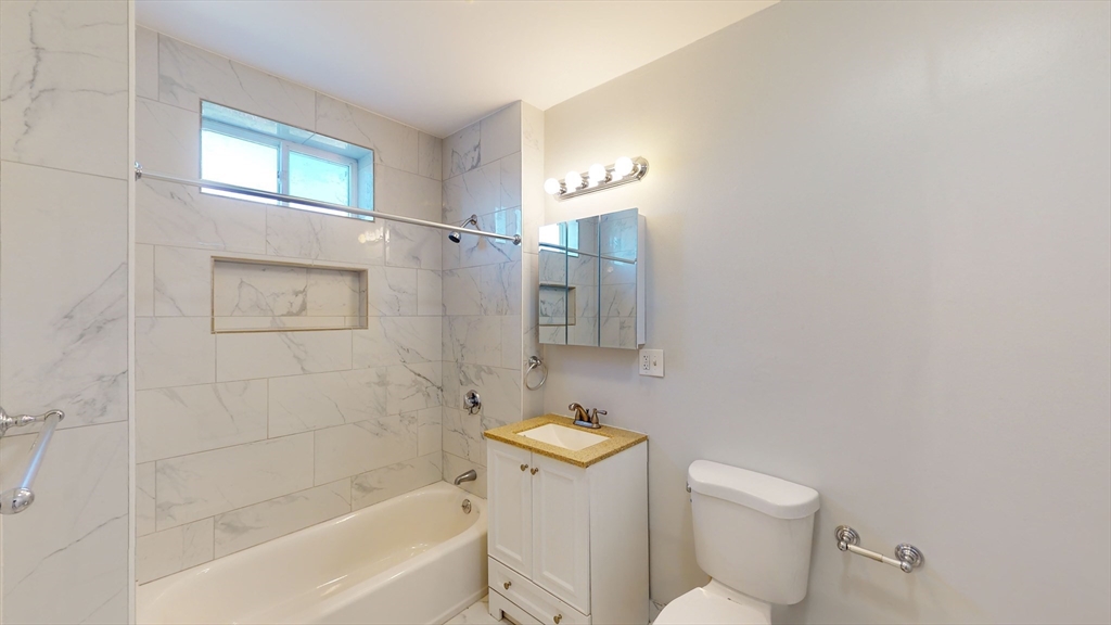2999 Washington Street, Unit 1 Boston, MA 02119 - Photo 7 of 18 a bathroom with a toilet and shower