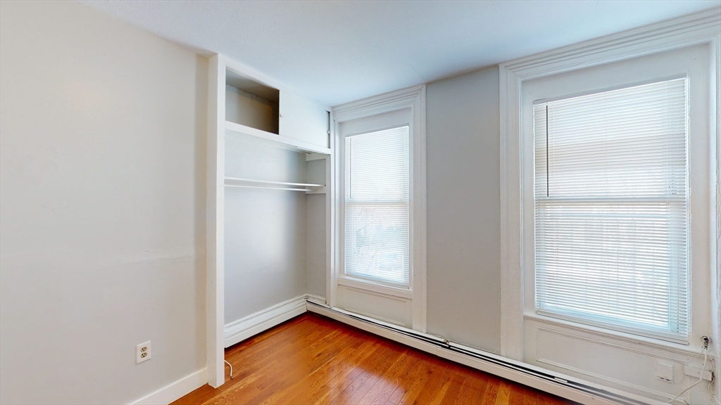 2999 Washington Street, Unit 1 Boston, MA 02119 - Photo 8 of 18 a view of empty room with window and wooden floor