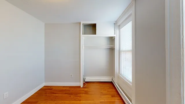 a view of room with window and wooden floor