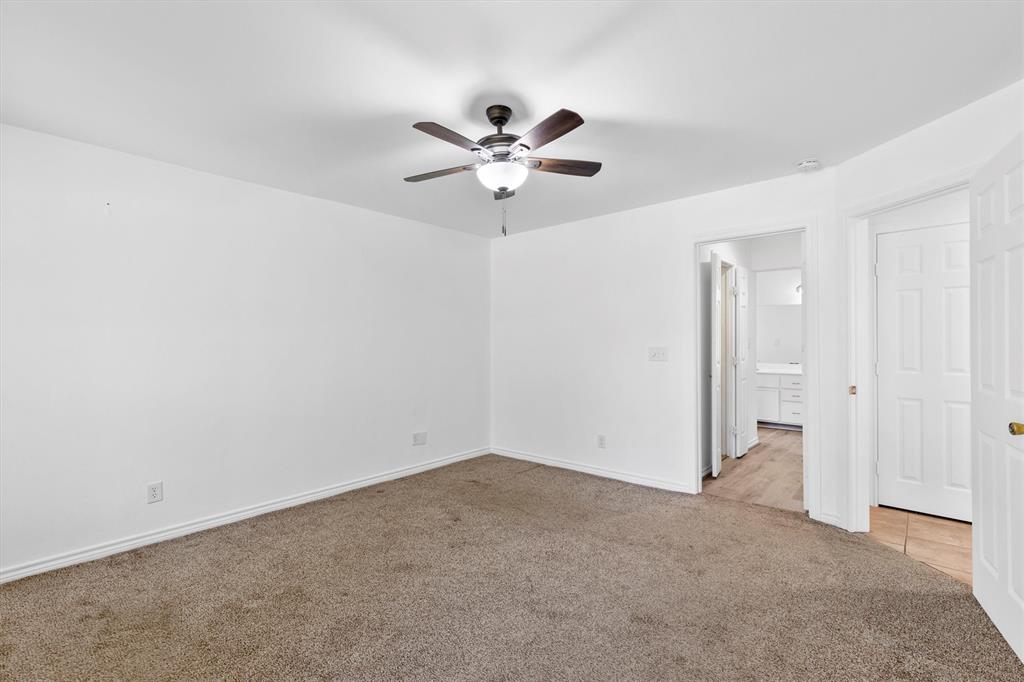 7578 Dick Price Road Mansfield, TX 76063 - Photo 13 of 40 an empty room with closet and a ceiling fan