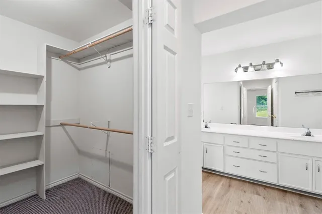 a bathroom with a double vanity sink and mirror