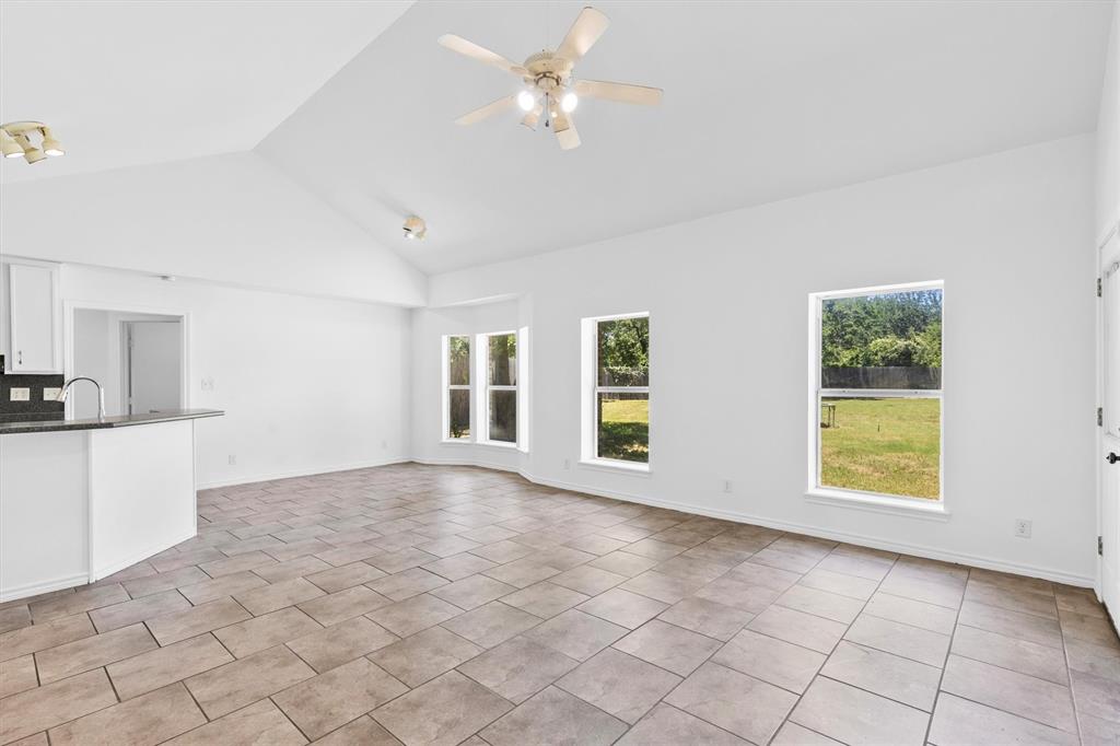 7578 Dick Price Road Mansfield, TX 76063 - Photo 19 of 40 a view of an empty room with a window and kitchen view