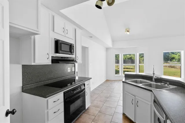 a kitchen with a sink stove and microwave