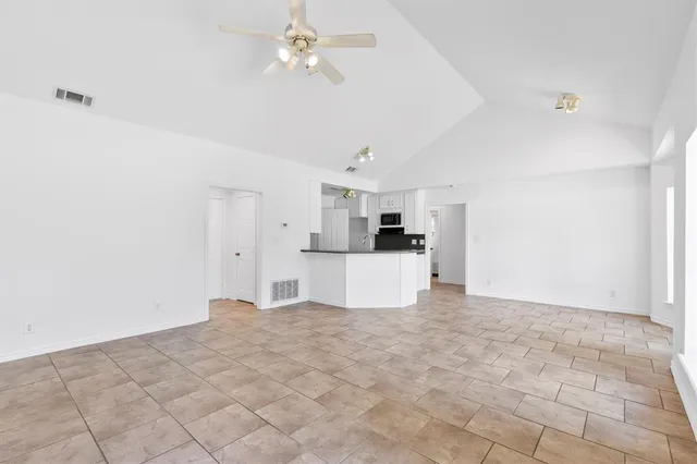 a view of a kitchen with a sink and a refrigerator