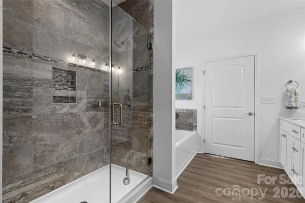 a bathroom with a glass shower door