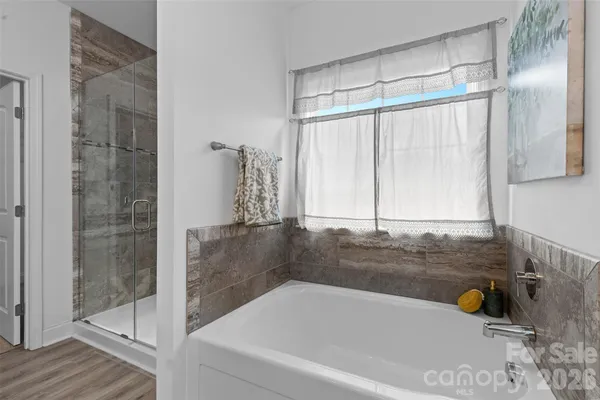 a bathroom with a bathtub and a shower