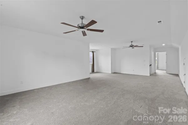 a view of a big room with a ceiling fan
