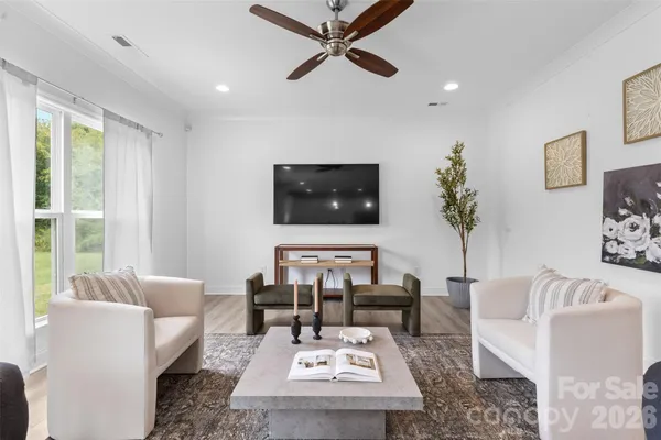 a living room with furniture and a large window