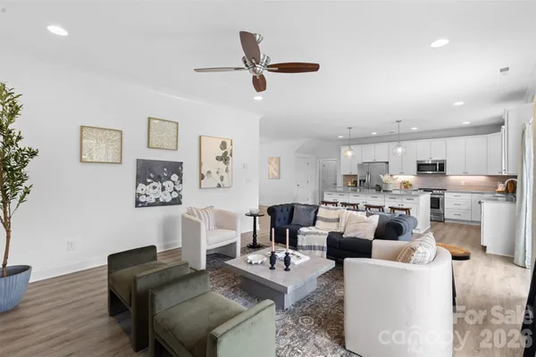 a living room with furniture and kitchen view