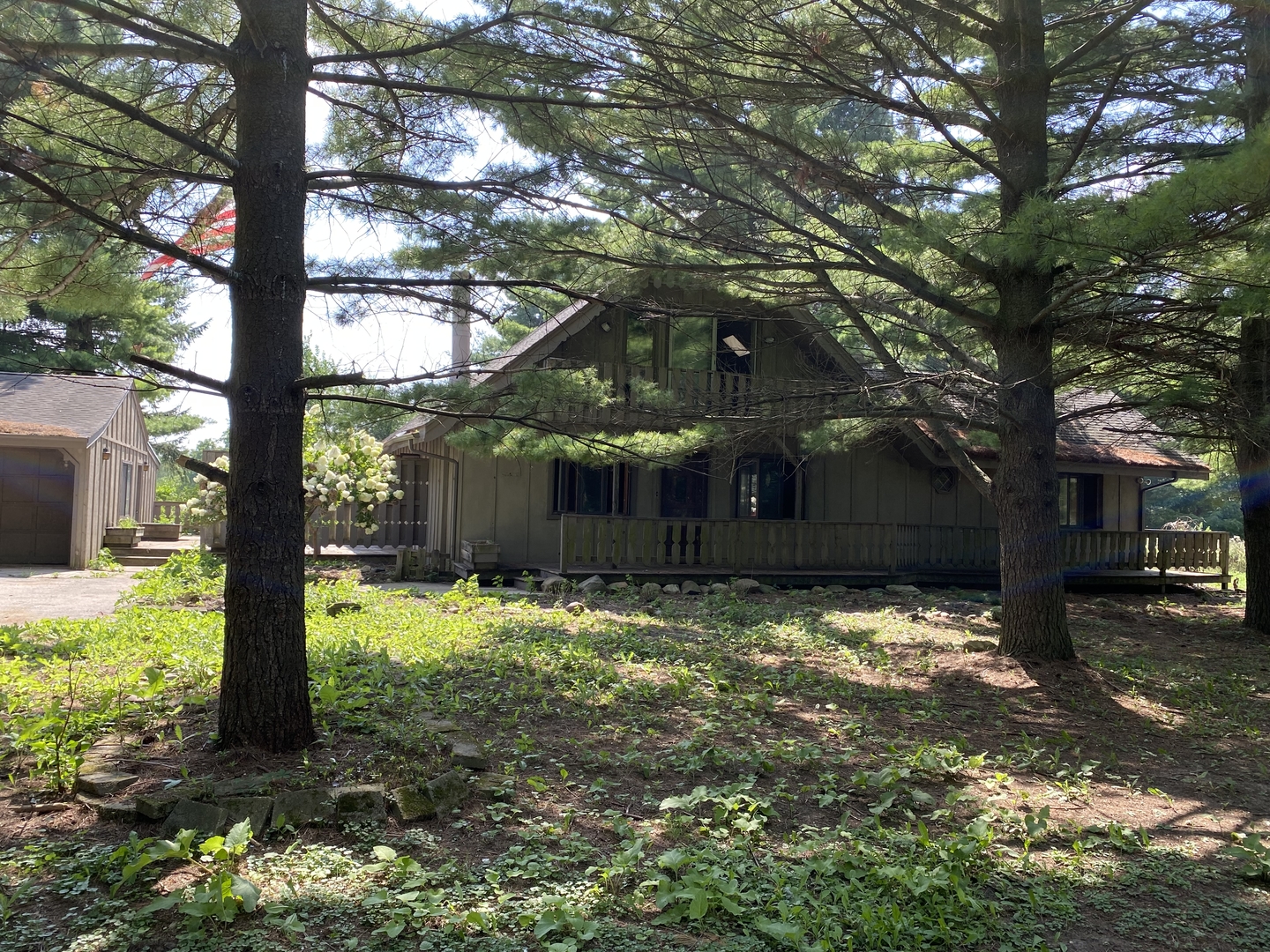 19209 Altenburg Road Harvard, IL 60033 - Photo 4 of 13 a house is sitting in middle of the forest